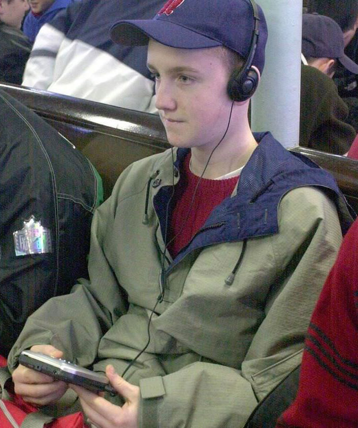 A Teen Listening To Music On A Portable Cd Player On The Staten Island Ferry, A Common Way To Listen To Music On The Go, 2001.