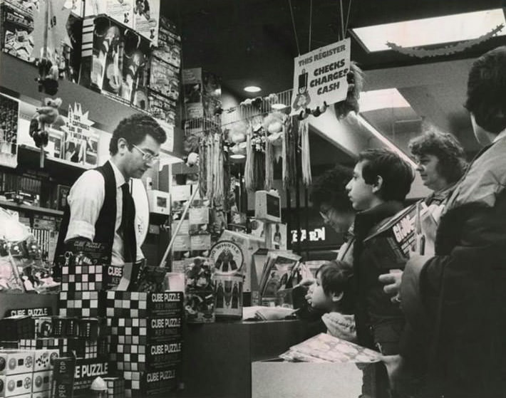 People Line Up To Return Or Exchange Christmas Gifts At Kay Bee Toy And Hobby Shop, 1982.