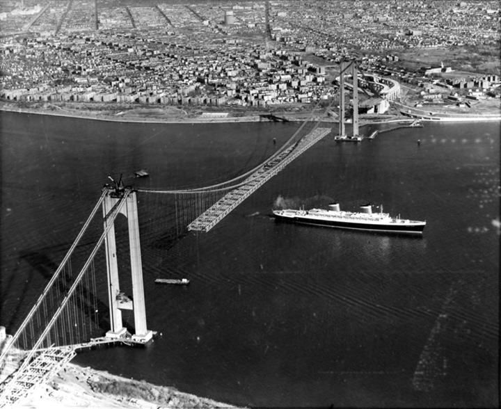A Ship Sails Beneath The Under-Construction Verrazzano-Narrows Bridge, December 1963