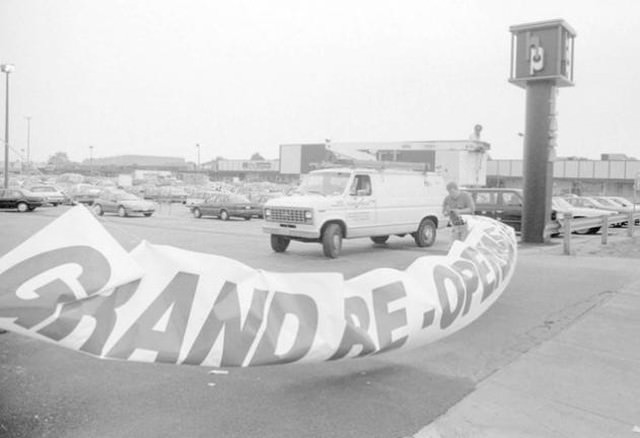 Worker Installs Grand Re-Opening Sign For Hylan Plaza, 1995