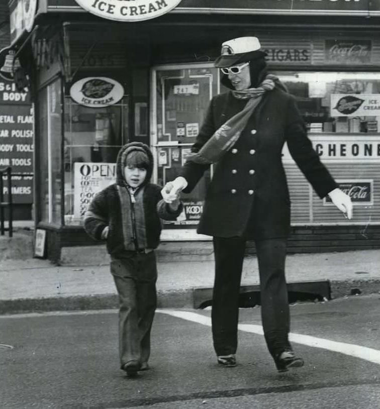School Crossing Guard Mrs. George Delpriora Guides William Corbet Safely Across The Intersection, 1972.
