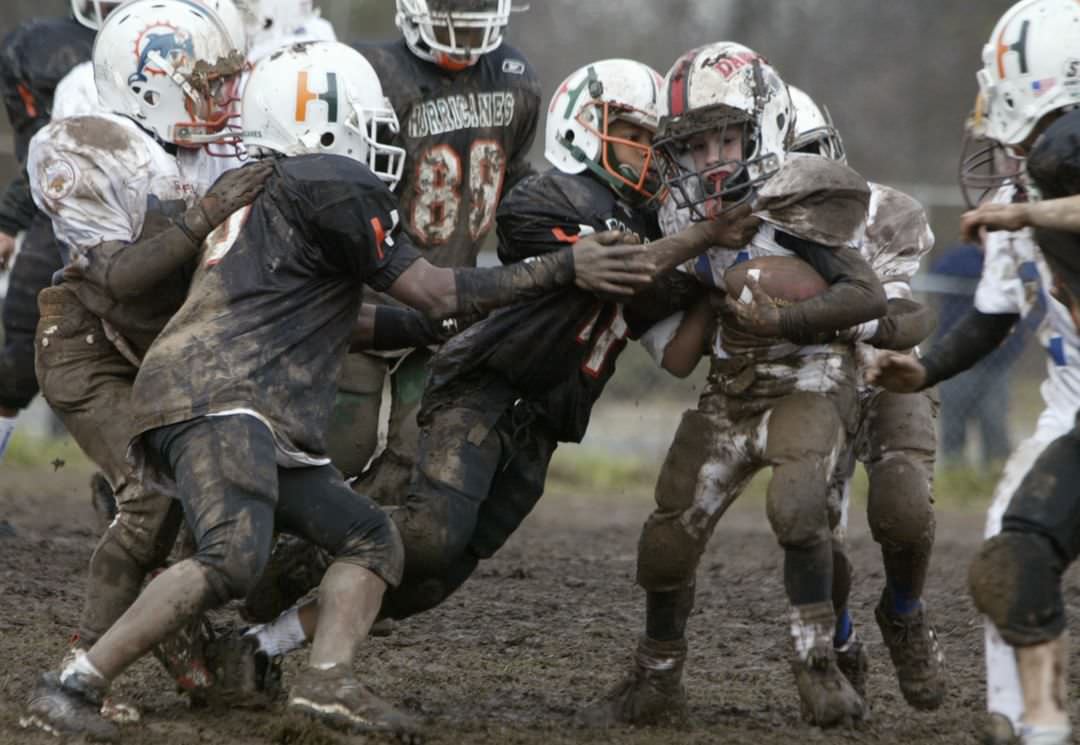 Mudbowl: Manny Caridad Of The Staten Island Boys All-Stars Tries To Get Through The Defense, 2004.