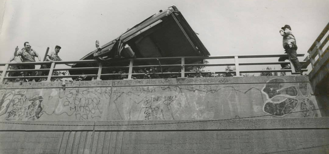 A Car Flipped Over On The Staten Island Expressway, Hanging Precariously Over A Railing, July 17, 1990