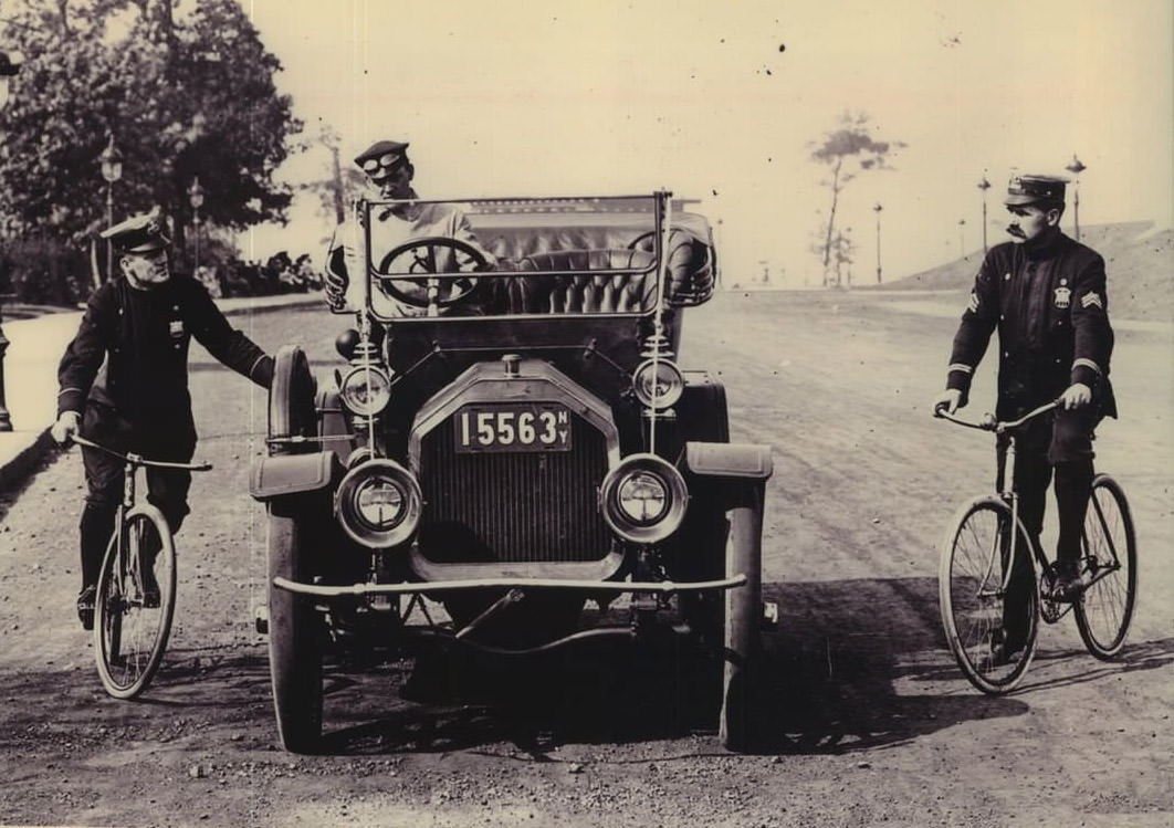 Policemen On Bicycles Talk With Passenger Car Driver, Circa 1920