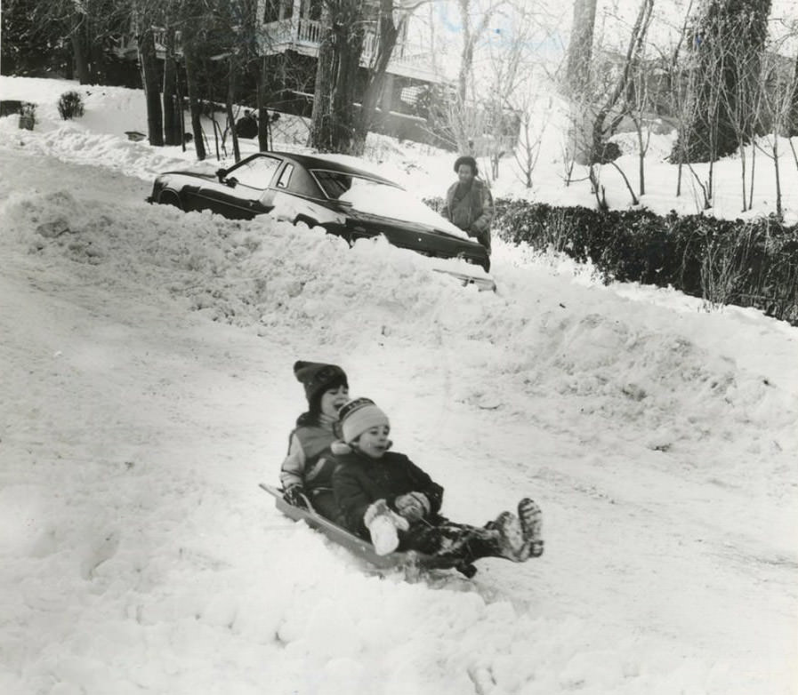 Blizzard Of '83: Motorist And Two Tots Sliding Down Fort Place In Tompkinsville, 1983.