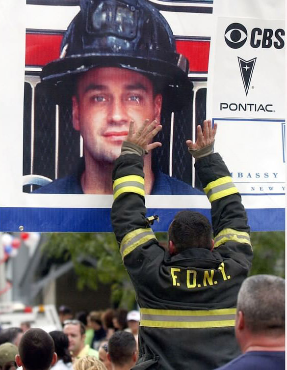 A Firefighter Touches A Photograph Of Stephen Siller At The 2005 Tunnel To Towers Run, 2005.