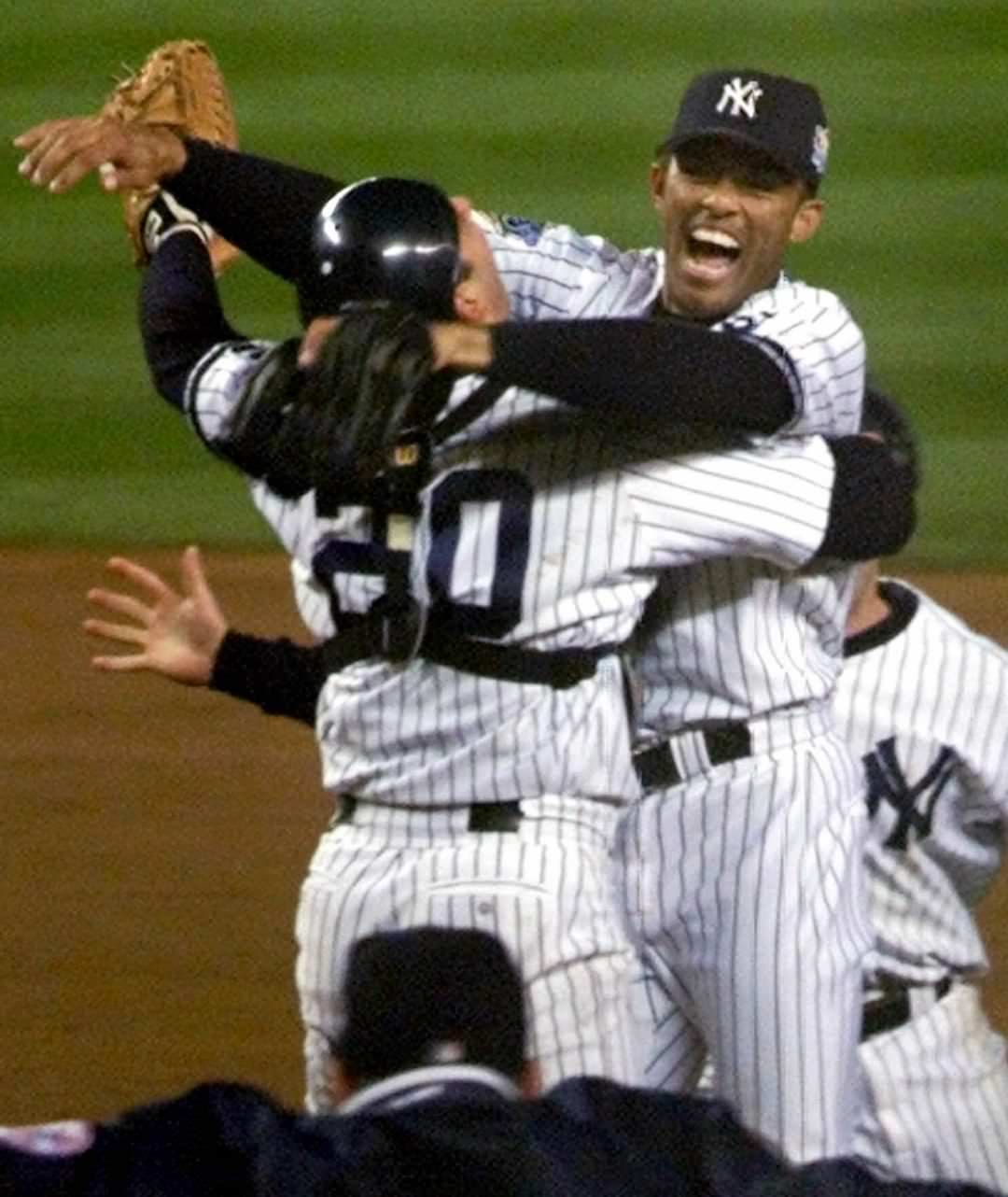 New York Yankees Pitcher Mariano Rivera Jumps Into Catcher Jorge Posada'S Arms After Defeating The Atlanta Braves In Game 4 Of The World Series, 1999.