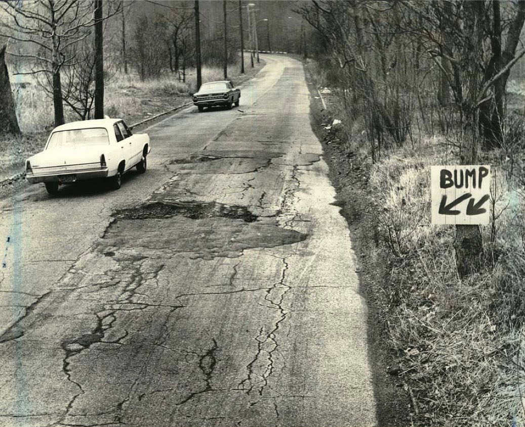 Homemade Sign Warns Motorists Of Pothole On Manor Road In Egbertville, 1970.