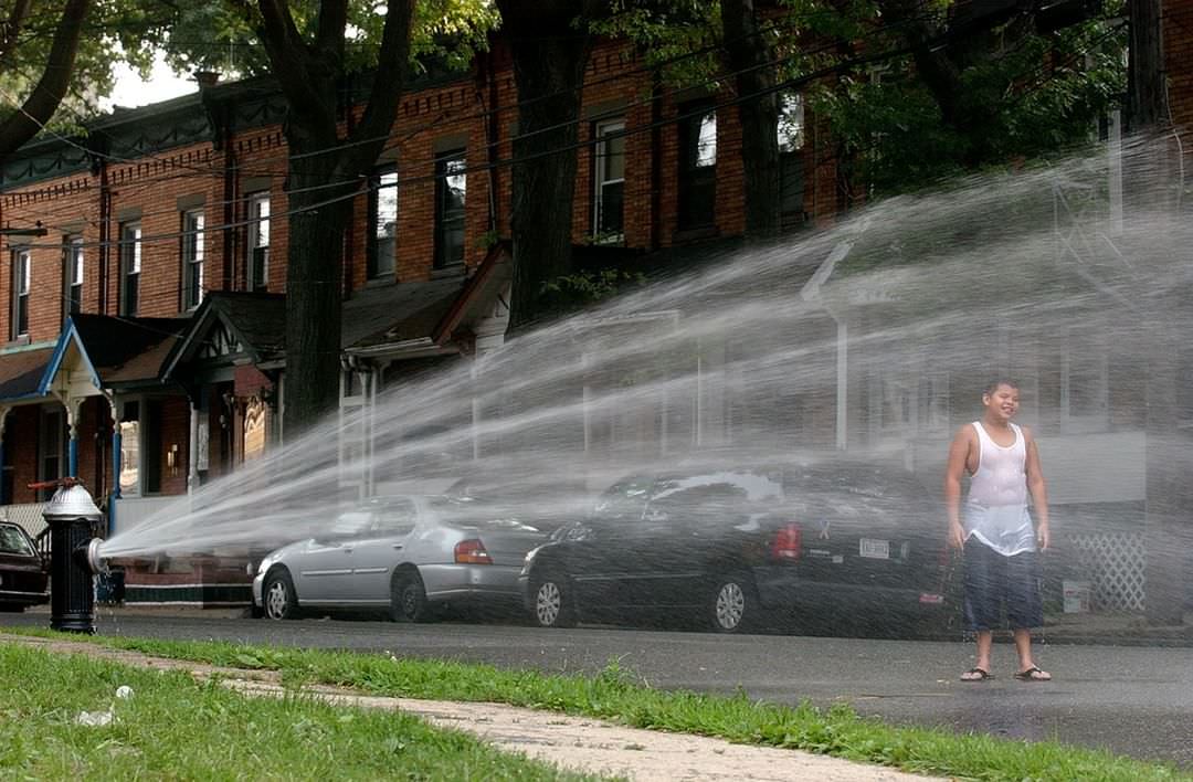 Noel Mariani Cools Off Under Fire Hydrant In Port Richmond, Temperatures Reached Triple Digits, 2006.