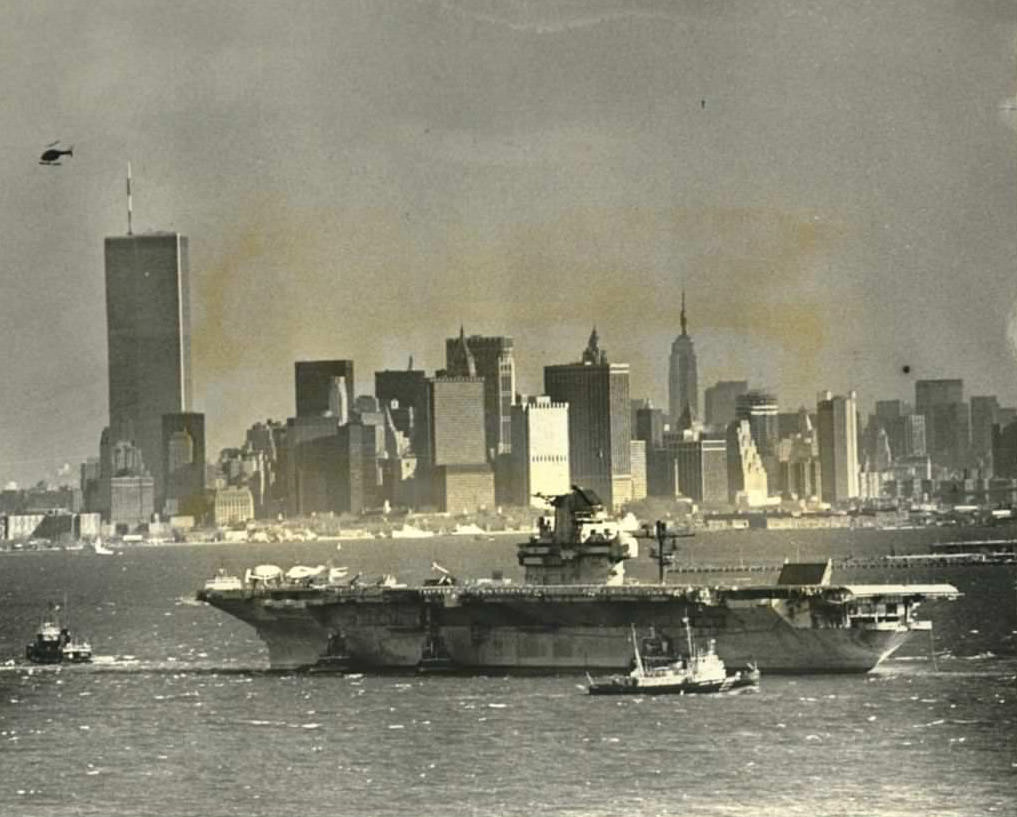 Aircraft Carrier Intrepid Towed To Bayonne Shipyard For Renovation, Twin Towers In Distance, 1982.