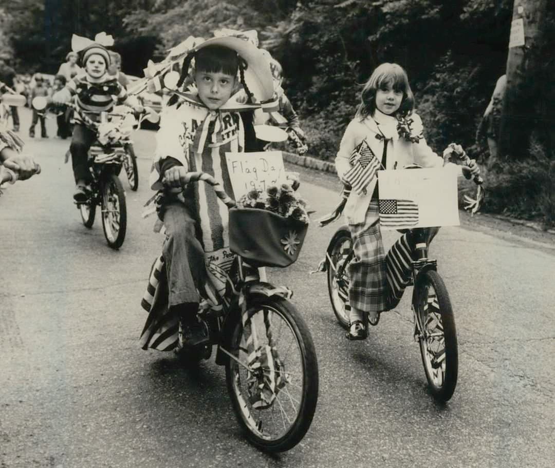 South Shore Children On Red, White, And Blue Decorated Bicycles Ride The Tottenville Flag Day Parade Route, Circa 1970S.