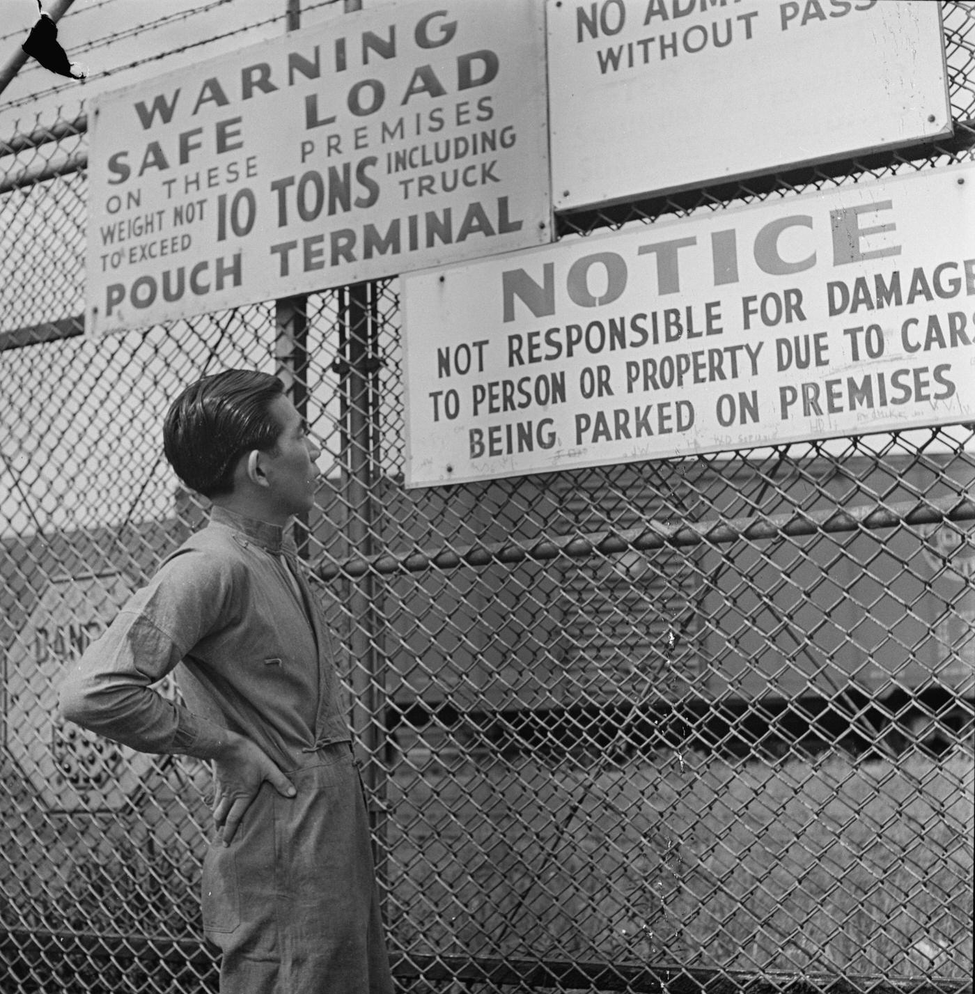 Chinese Mariner Lee Ah Ding Reading Dock Gate Notices At Pouch Terminal, Staten Island, September 1942.
