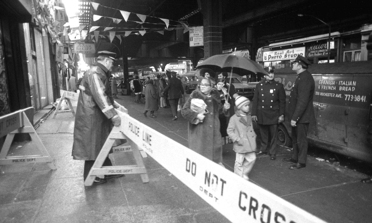 Woman And Boy Observe Police Guarding John &Amp;Amp; Al Sports Store After Brooklyn Siege, 1973