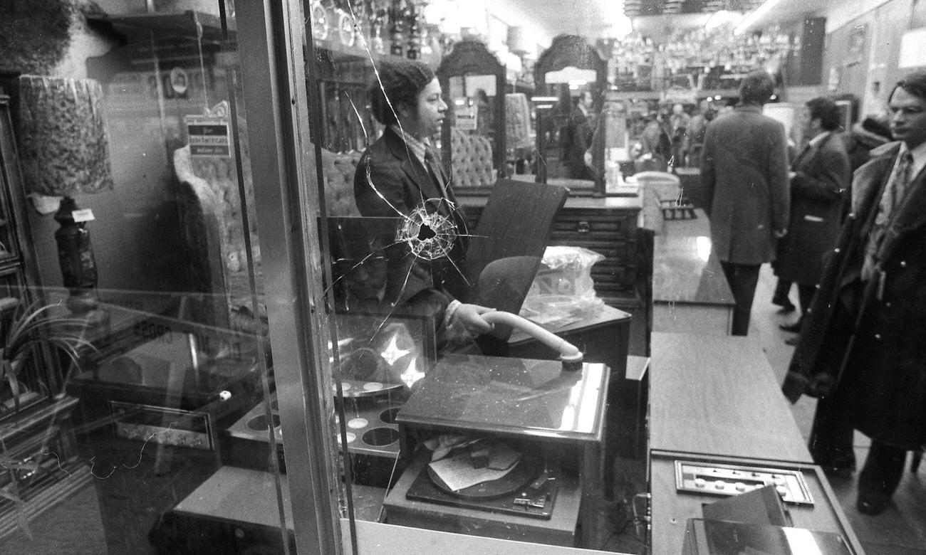 Man Vacuums Shattered Glass Near Scene Of Brooklyn Hostage Siege, 1973