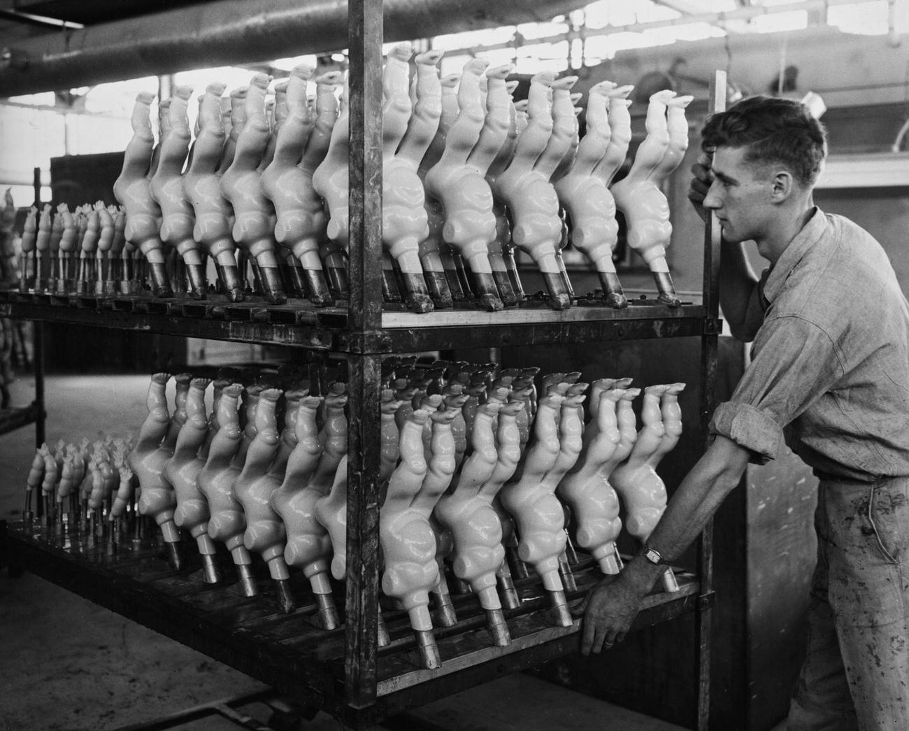 Man Pushing Carriage Of Headless Dolls In Brooklyn Toy Factory, November 19, 1934