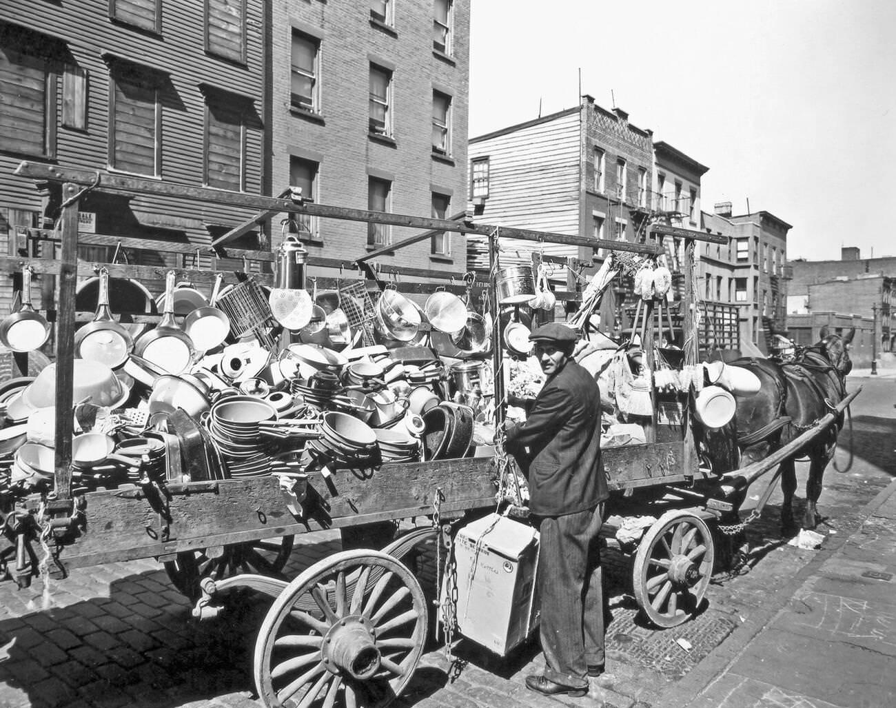 Tinker Looks Over His Shoulder While Tying A Box To His Wagon In Brooklyn, Circa 1936.