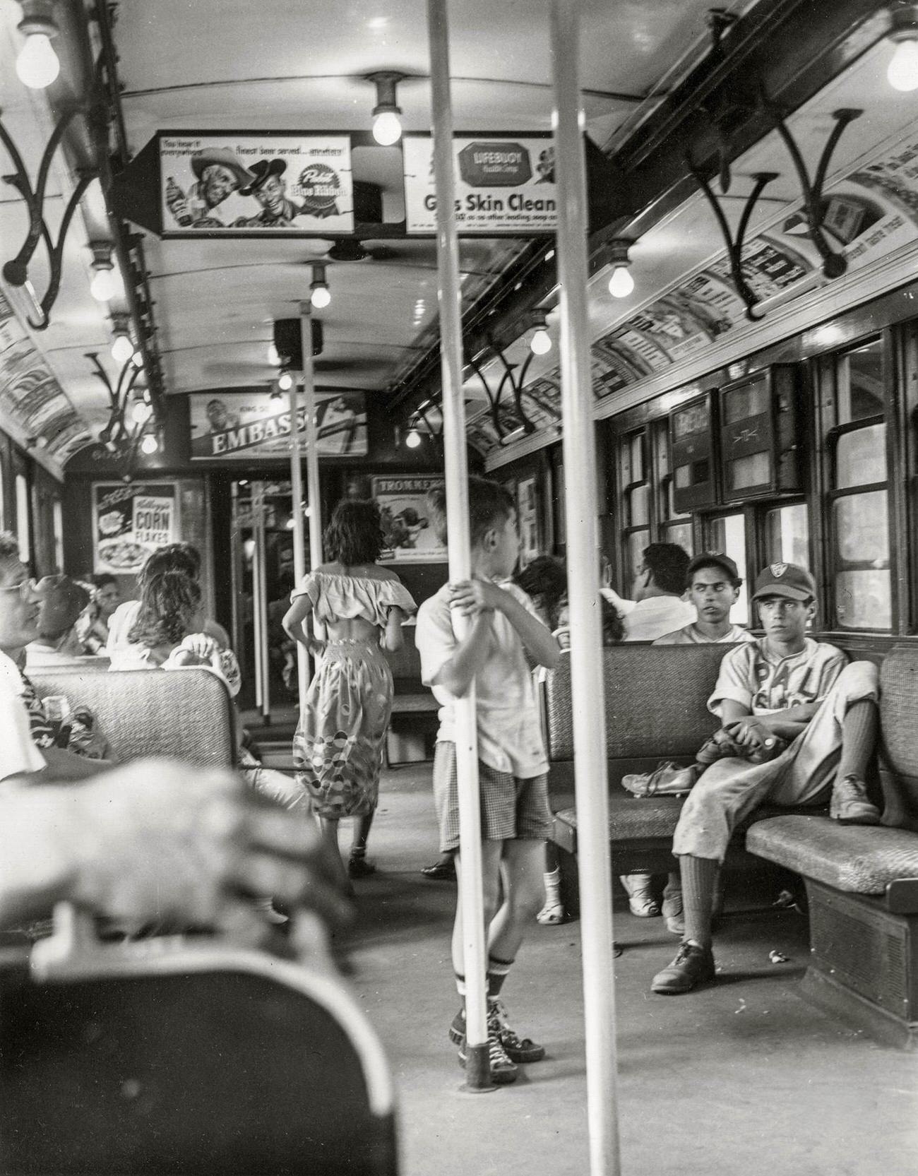 When Day Is Done In Brooklyn (Boys In Advertisement-Covered Subway Car Filled With Passengers), New York City, 1949