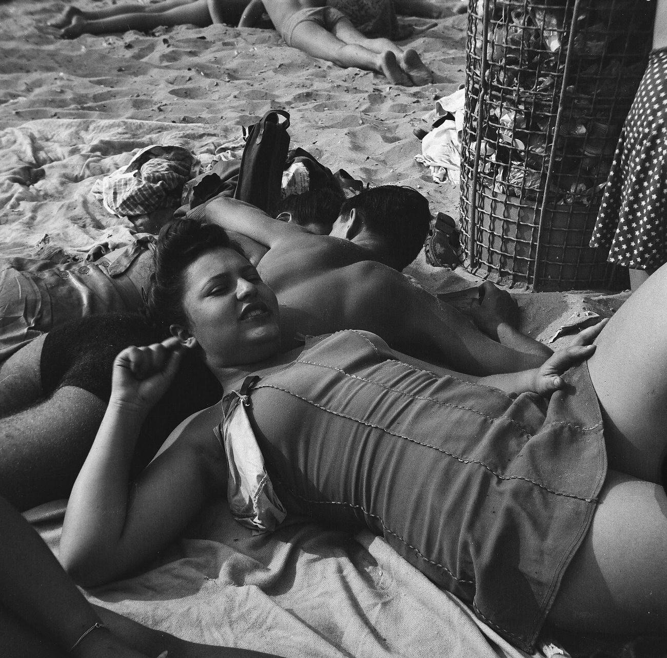 Young Couple Relaxing On The Sand At Coney Island Beach, 1944