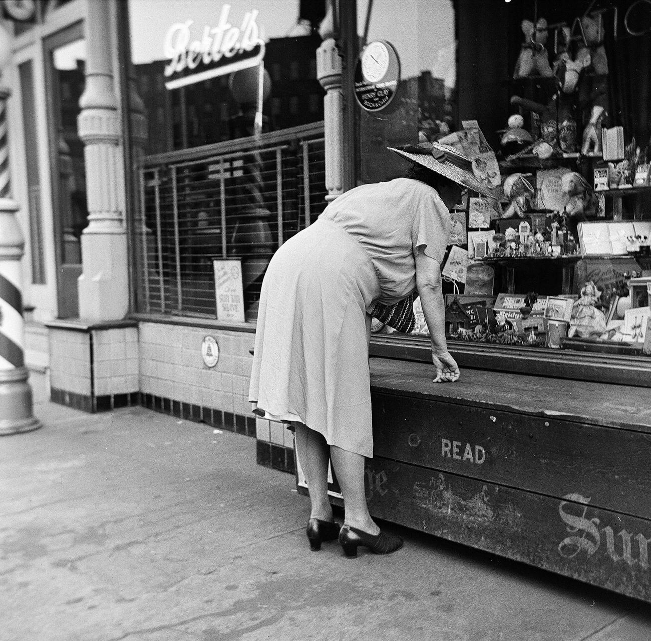 Woman Leaning In To Examine Items In A Store Window, Brooklyn, 1945