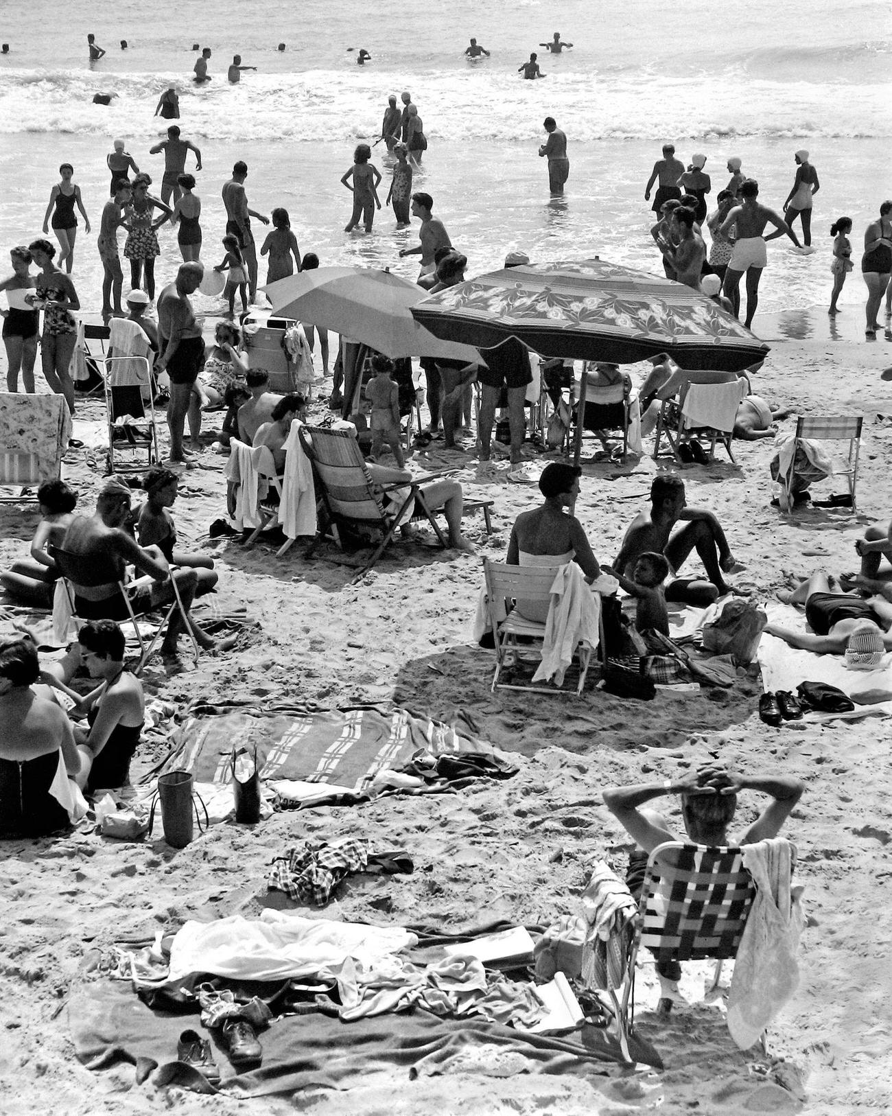 Beachgoers Sunbathing And Swimming At Coney Island Beach, Brooklyn, 1950.