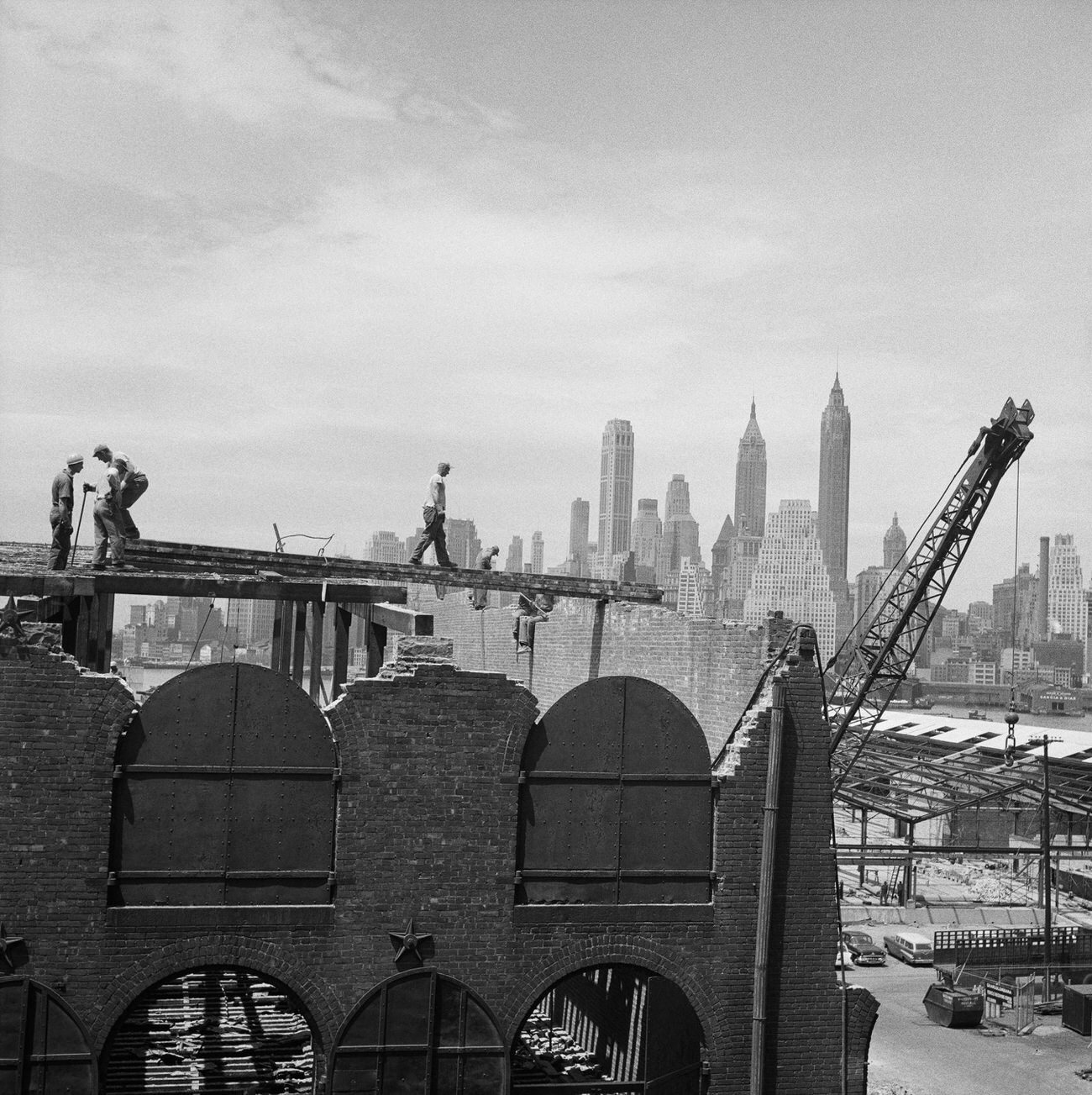 Construction Workers Build Against The Manhattan Skyline In Brooklyn Heights, 1958.