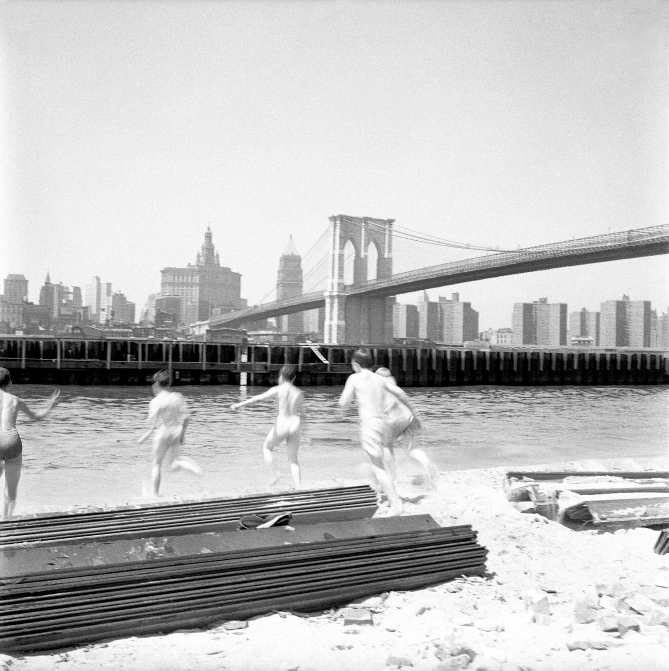 Kids Swim In The East River With Brooklyn Bridge In The Background, 1958.