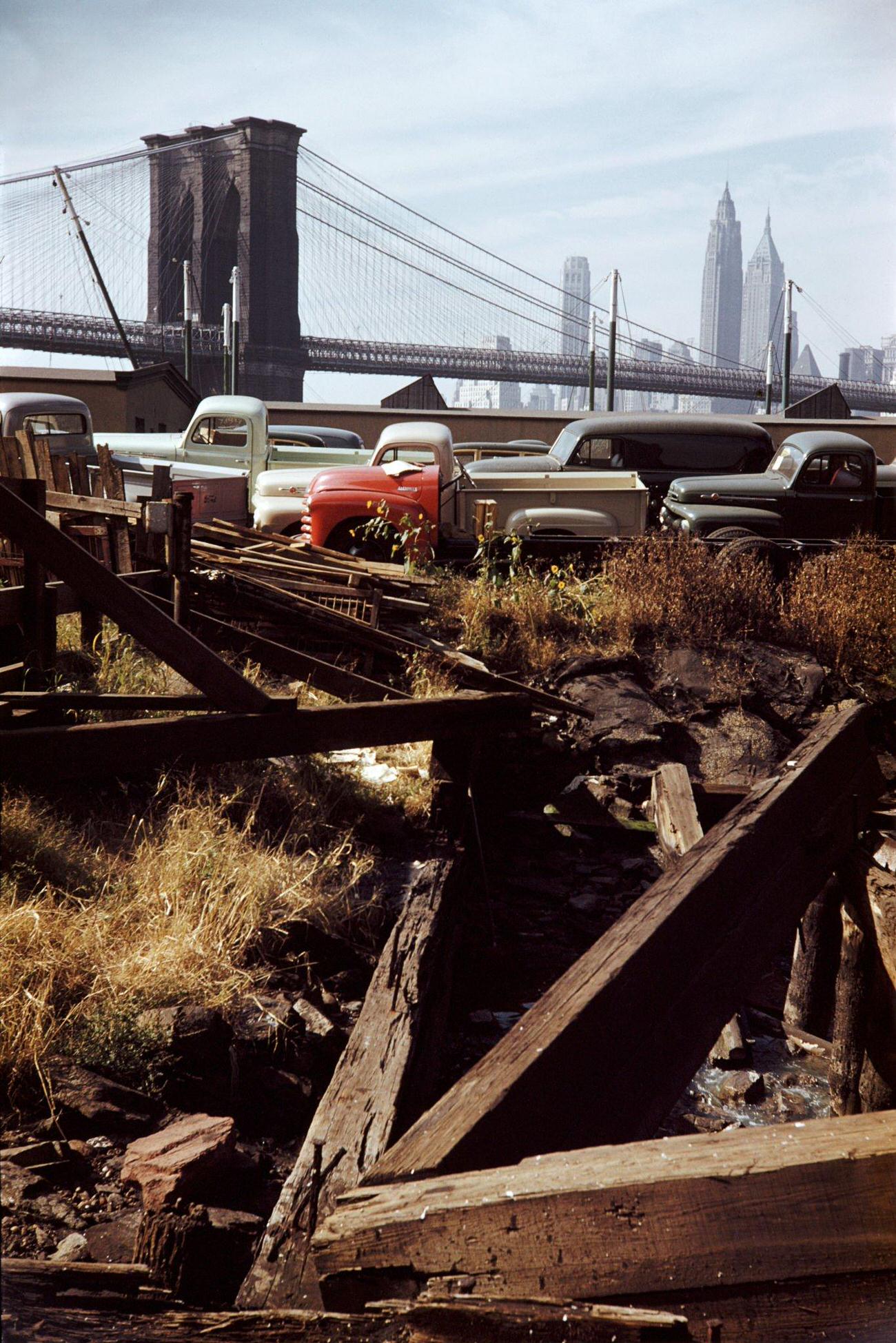 Trucks In A Brooklyn Junkyard With Brooklyn Bridge In Background, 1952.