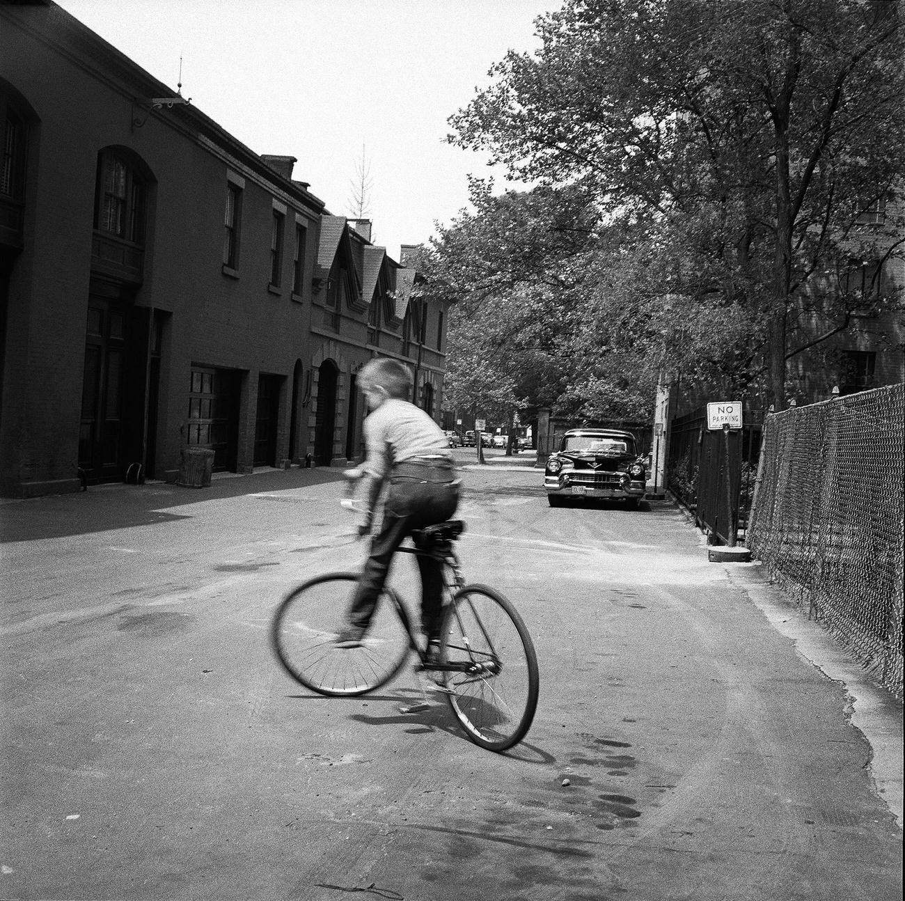 Young Boy Riding His Bicycle On The Street In Brooklyn Heights, 1958.