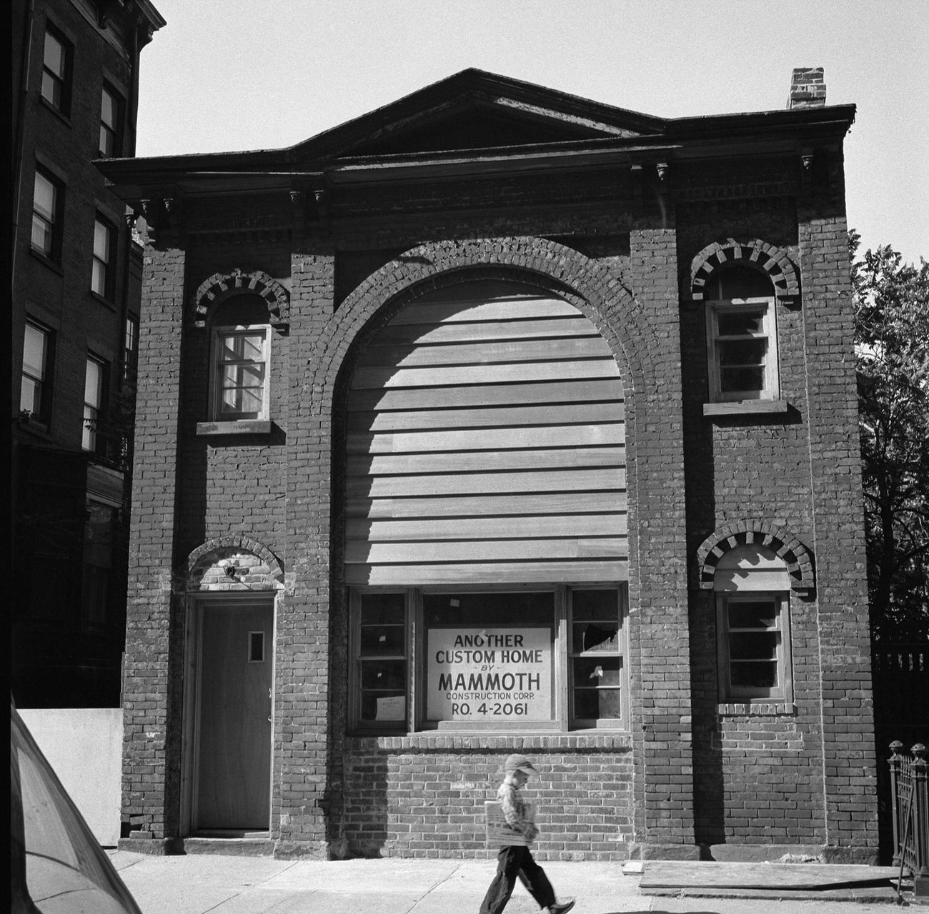 Boy With Newspaper Walks By A Historic Carriage House At 31 Pineapple Street, Brooklyn Heights, 1958.