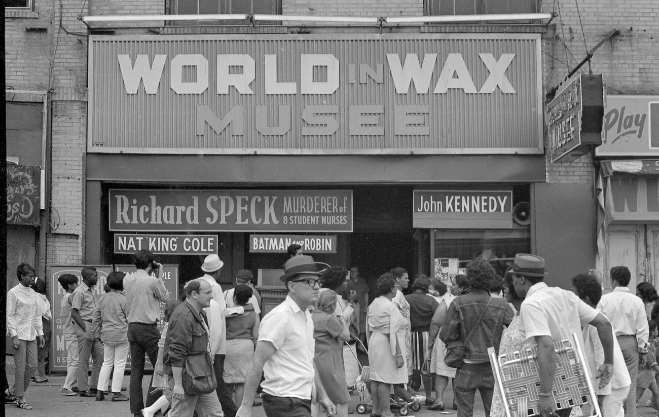 Pedestrians In Front Of World In Wax Musee At Coney Island Advertising Exhibits Like Richard Speck And Nat King Cole, 1968.