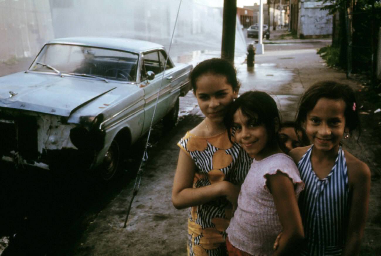 Three Young Girls Pose In Front Of An Abandoned Car In Brooklyn, 1973