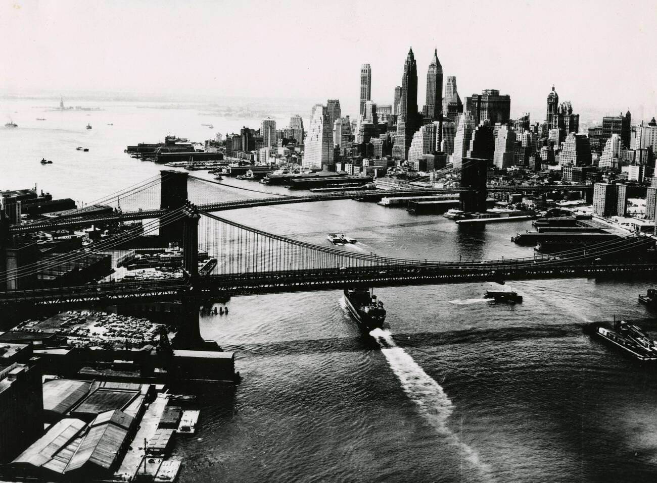 Aerial View Of The East River Featuring The Manhattan And Brooklyn Bridges, 1970S.