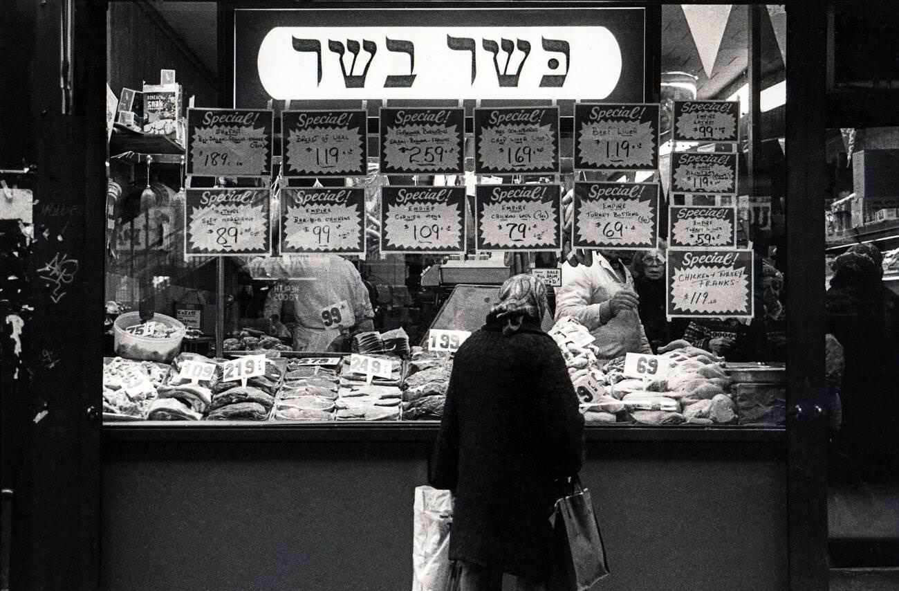 Jewish Woman Window Shopping At A Kosher Butcher Shop In Brighton Beach, Brooklyn, 1970S.