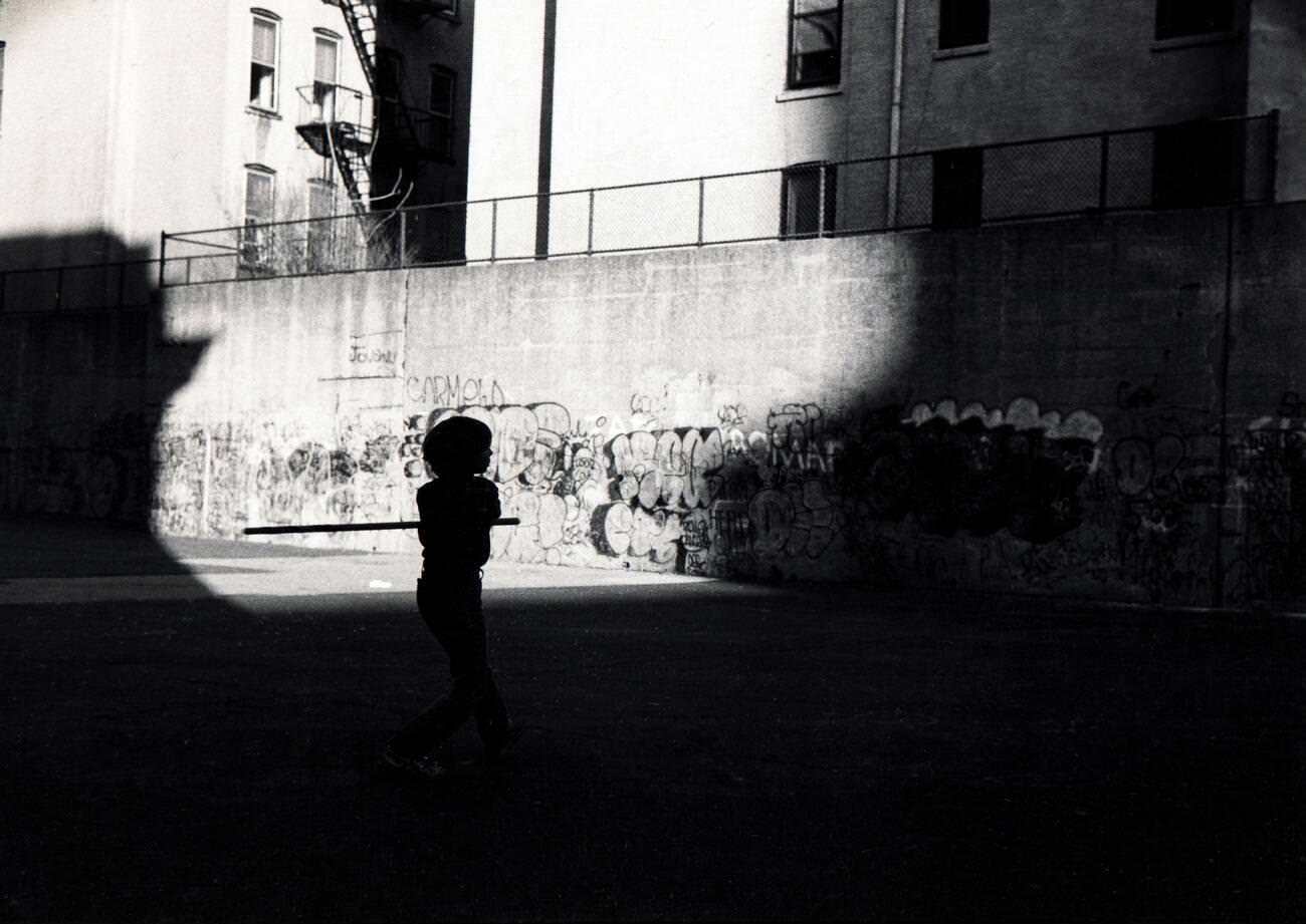 Young Teenager'S Silhouette Playing Stickball In Park Slope, Brooklyn, 1978.