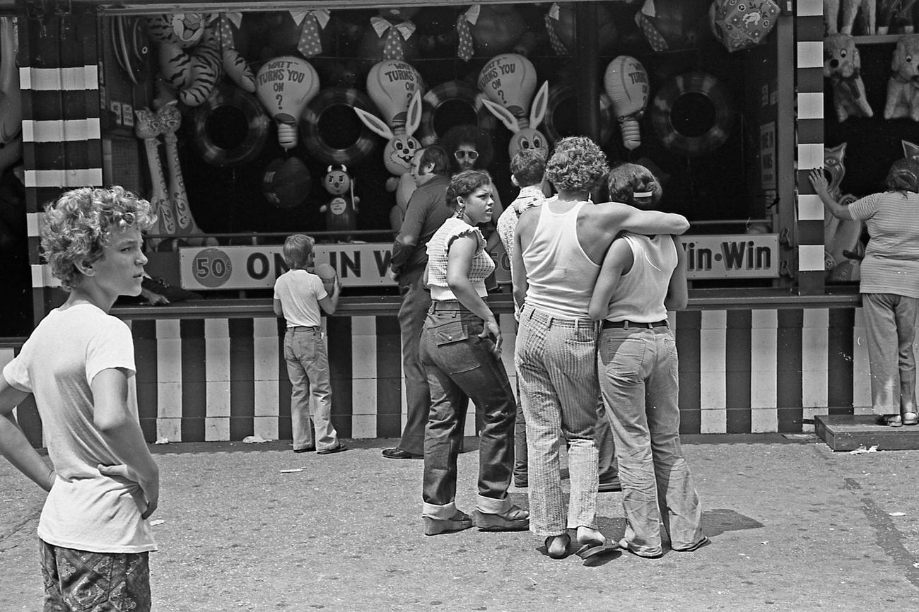 Group In Front Of Gaming Booth At Astroland Park, Coney Island, Brooklyn, 1973