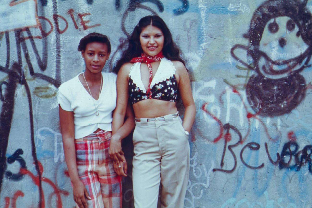Two Teenage Girls In Front Of Graffiti Wall, Lynch Park, Brooklyn, 1974