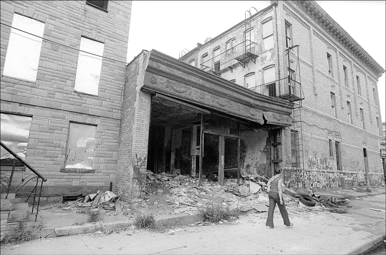 Woman Walking Past Ruined Buildings In Bushwick, Brooklyn, 1970S