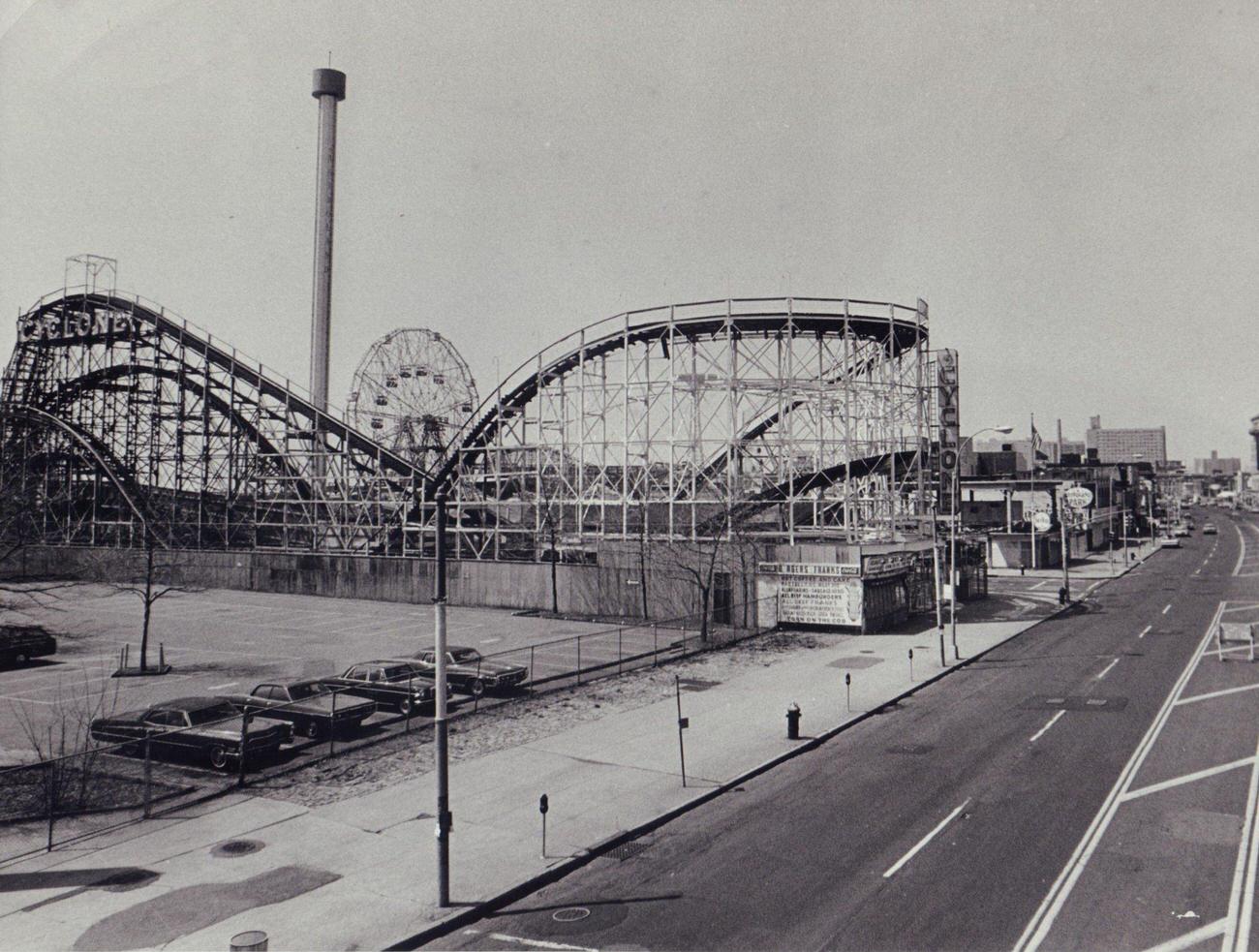 Surf Avenue In Coney Island With Cyclone Roller Coaster And Wonder Wheel, Brooklyn, 1975.