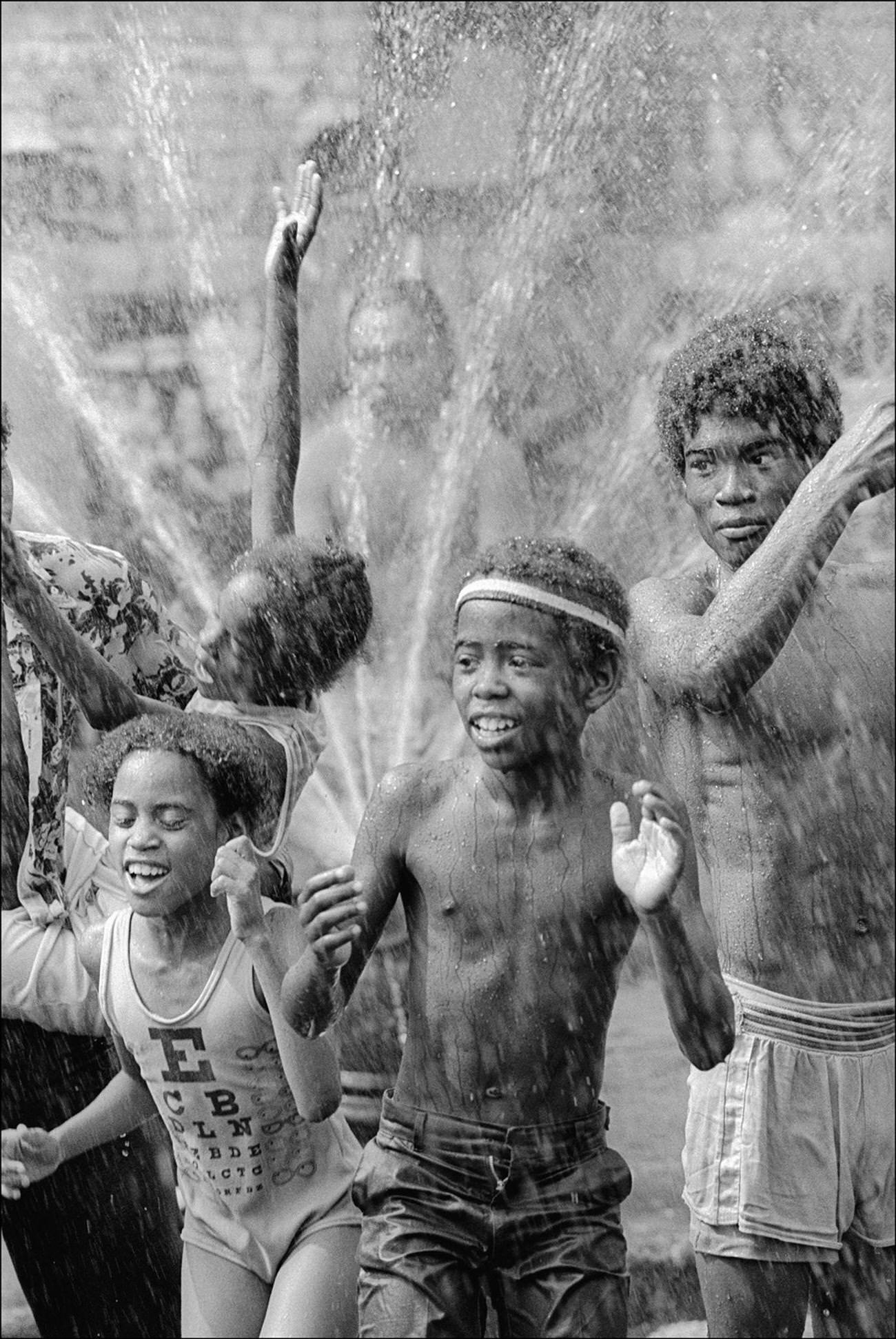 Children Cool Off Under The Spray From A Fire Hydrant Sprinkler In Brooklyn'S Bushwick Neighborhood, Brooklyn, 1977