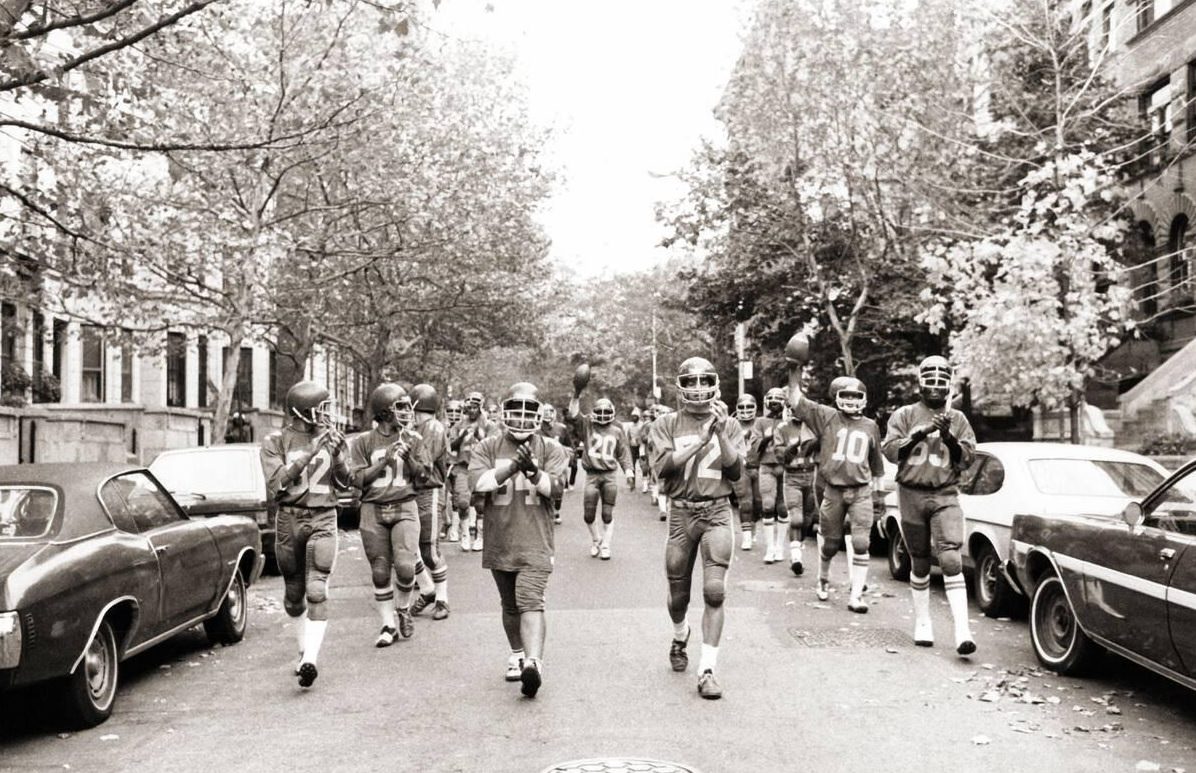 John Jay High School Football Team Marches From Practice Field, Brooklyn, 1982.
