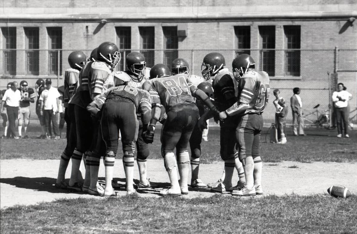John Jay High School Football Team In Huddle, Brooklyn, 1983.