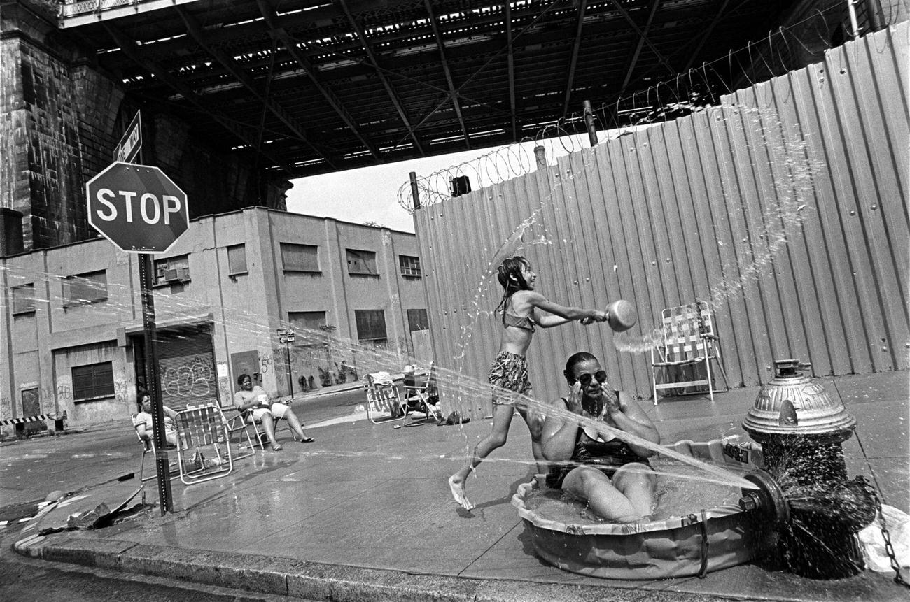 Woman Sits In Plastic Pool Under Manhattan Bridge In Brooklyn, 1993