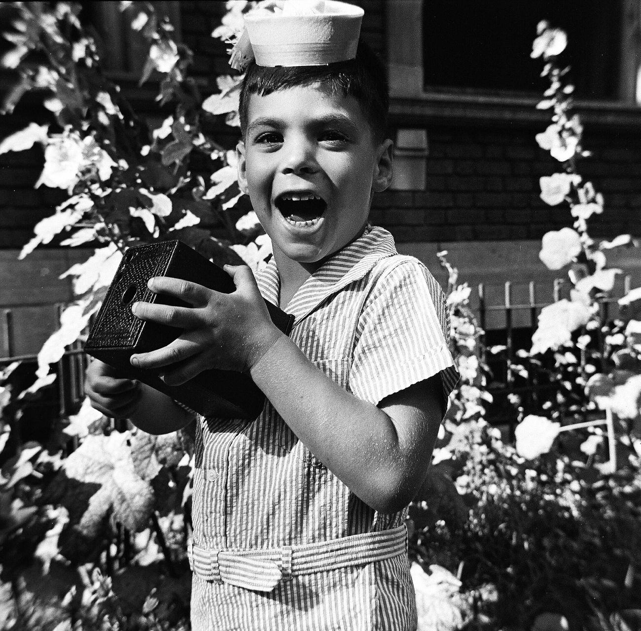 Boy Making A Face While Holding A Camera, 1944