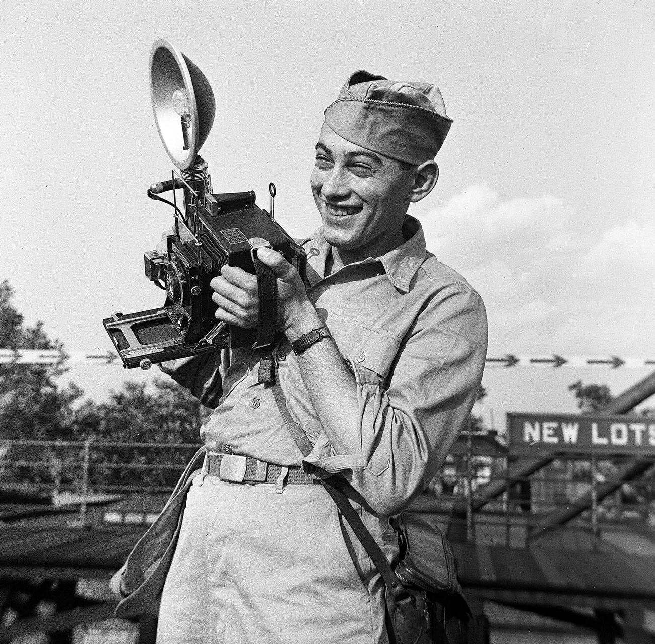 Soldier Holding A Camera On A Subway Platform, 1945