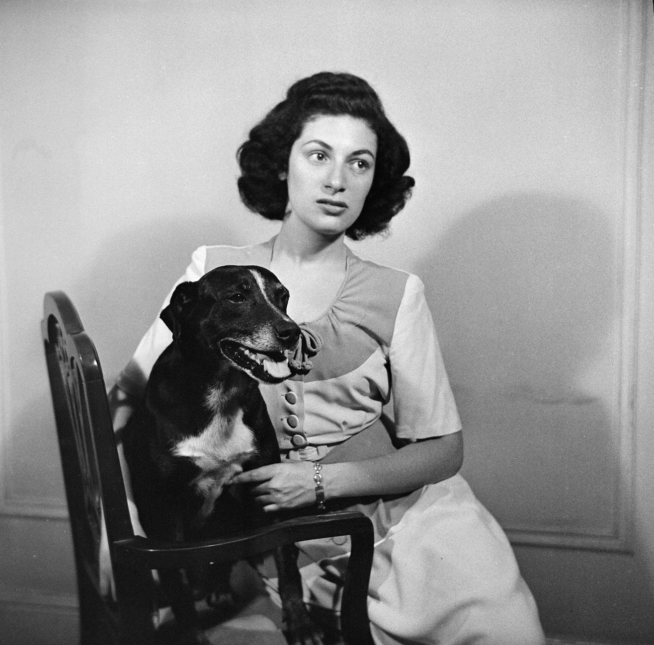 Woman Sitting In A Chair With A Dog, 1945