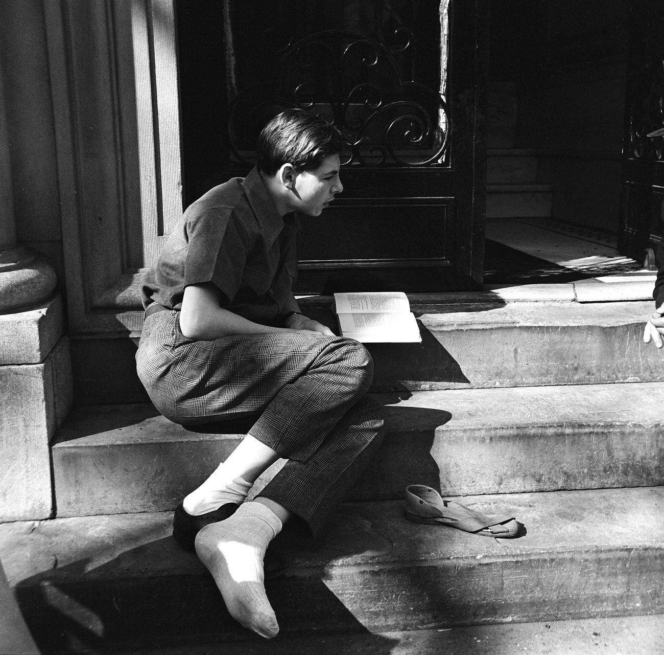 Boy Reading A Book On A Stoop, 1945