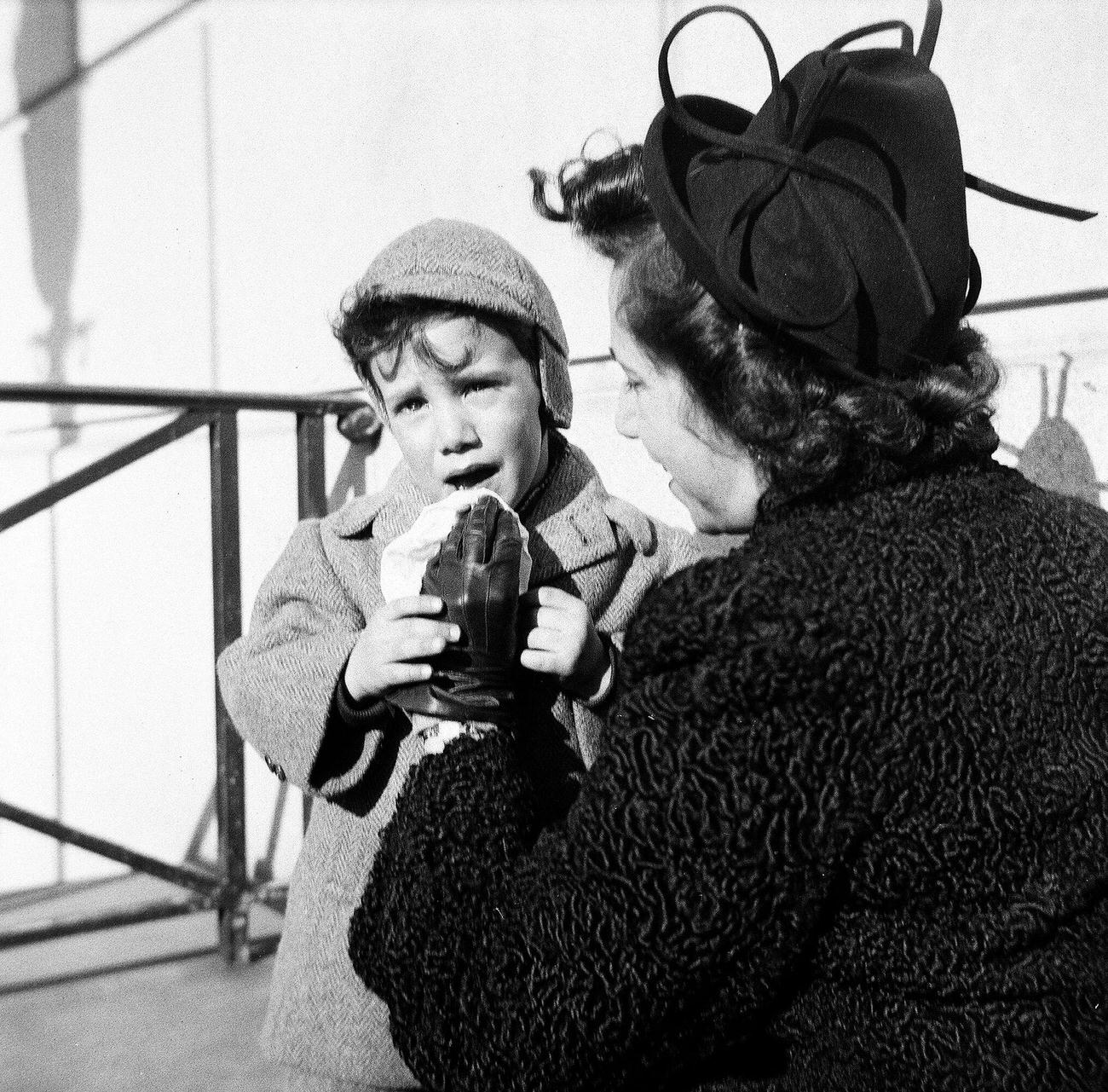 Woman Wiping The Mouth Of A Crying Boy, 1944