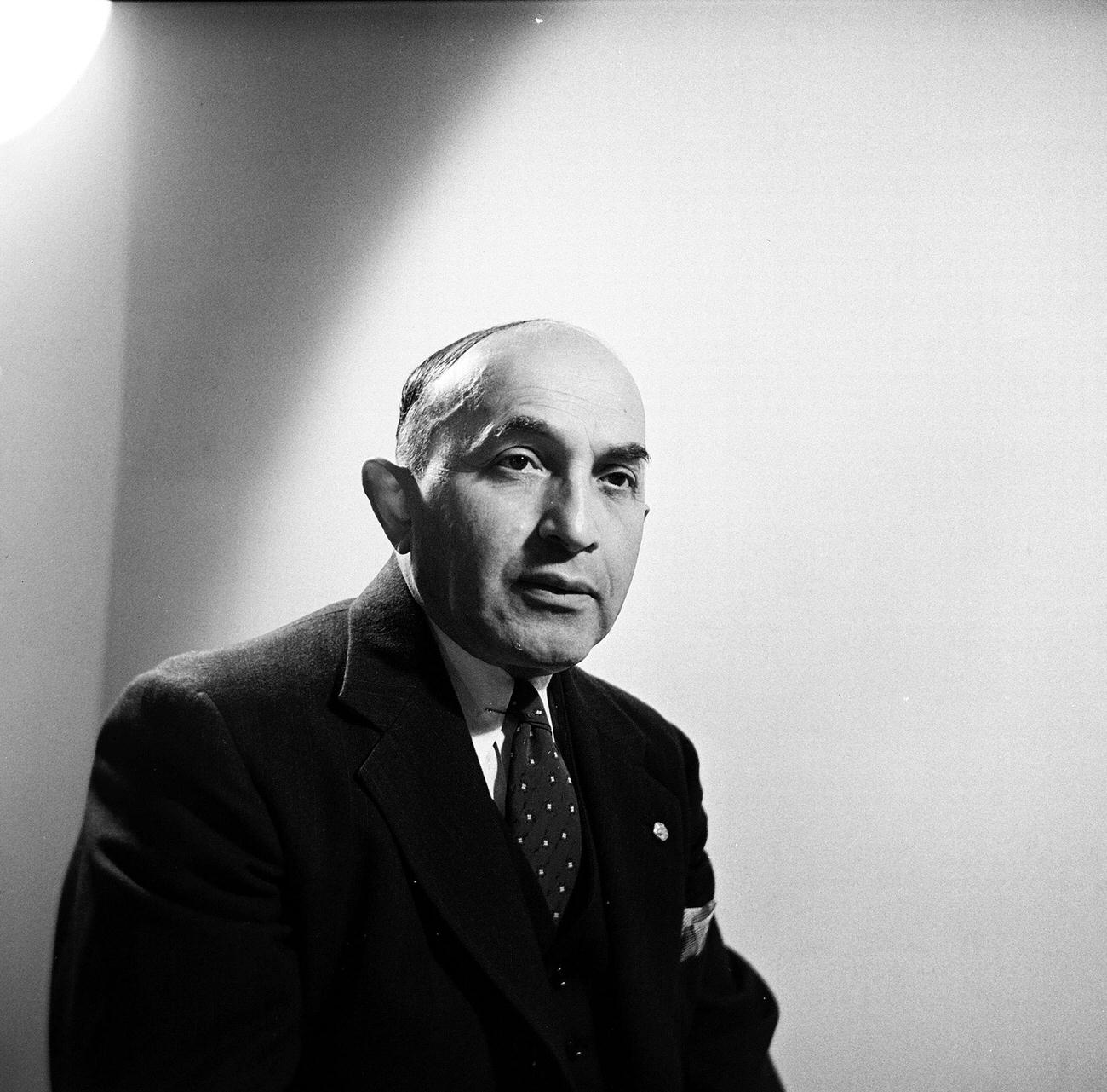 Adolf Schlussel In A Dark Suit Posing In A Studio, 1945