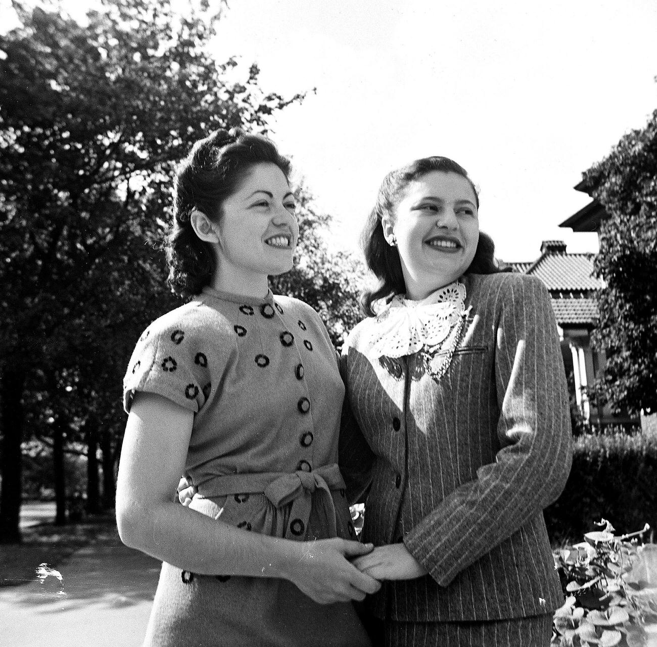 Women Holding Hands And Smiling Outdoors, 1945