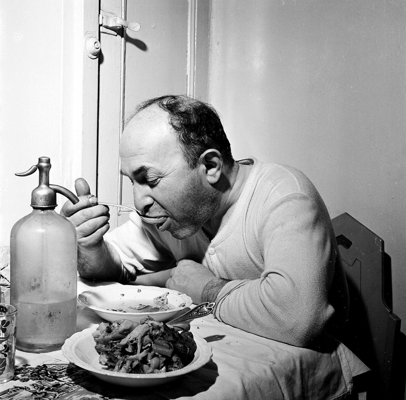 Man Eating A Meal At A Kitchen Table, 1945